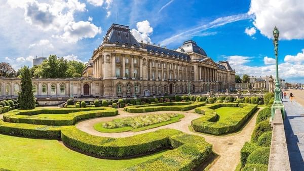 Royal Palace of Brussels with manicured hedges placed in the garden near Warwick Grand Place Brussels