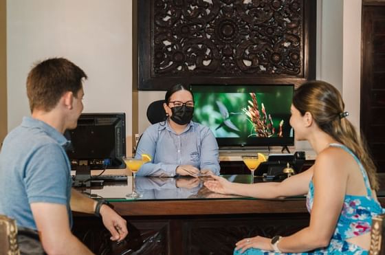 A couple talking with a hotel staff at Rio Celeste