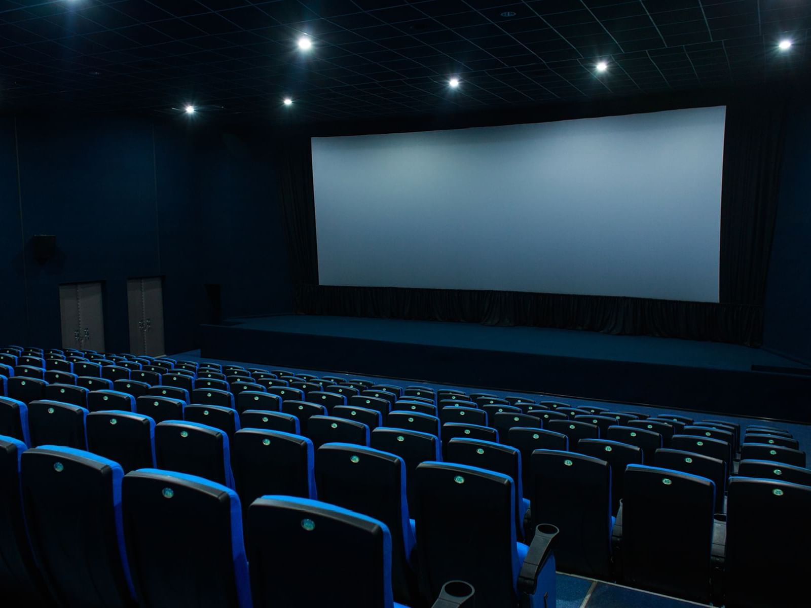 Interior of a Theatre with a large screen at Fiesta Inn Hotels