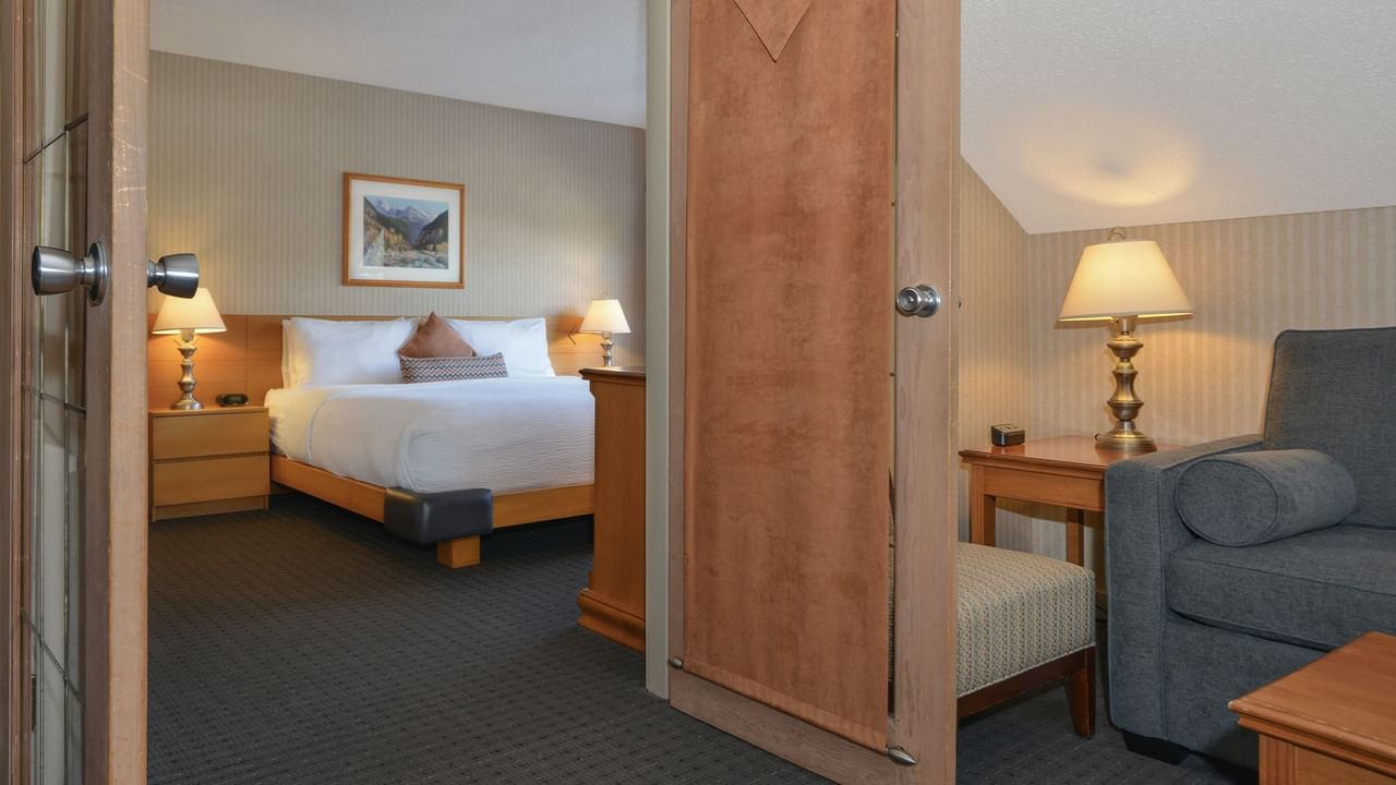 Hotel suite with king bed and sofa.