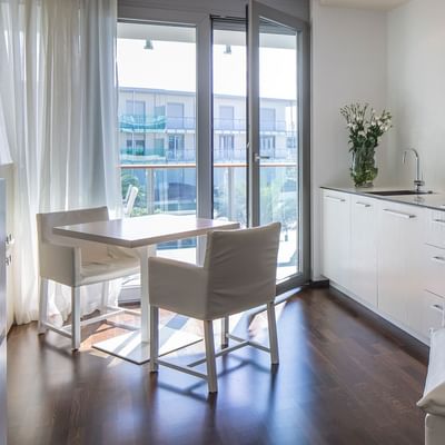 Apartment A Kitchenette & dining table at Falkensteiner Hotels