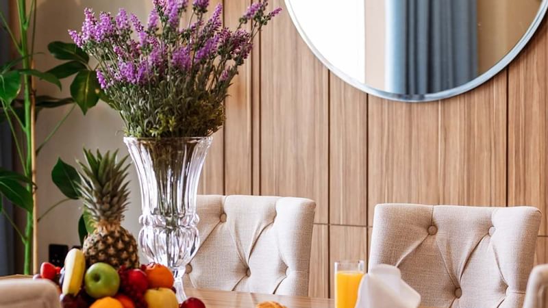 Dining table with fruits and snacks in the Presidential Suite at Cantonal Hotel by Warwick Riyadh