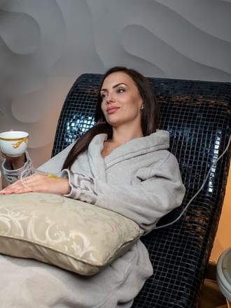 Laying woman undergoing treatment in the spa at Palazzo Versace