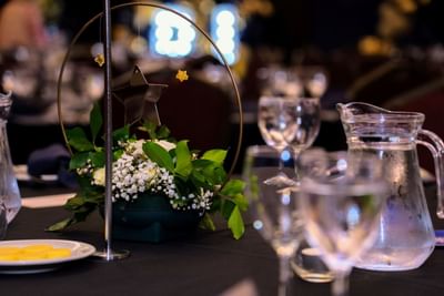 An elegant table setting with a star themed floral centerpiece at the Royal on the Park Hotel
