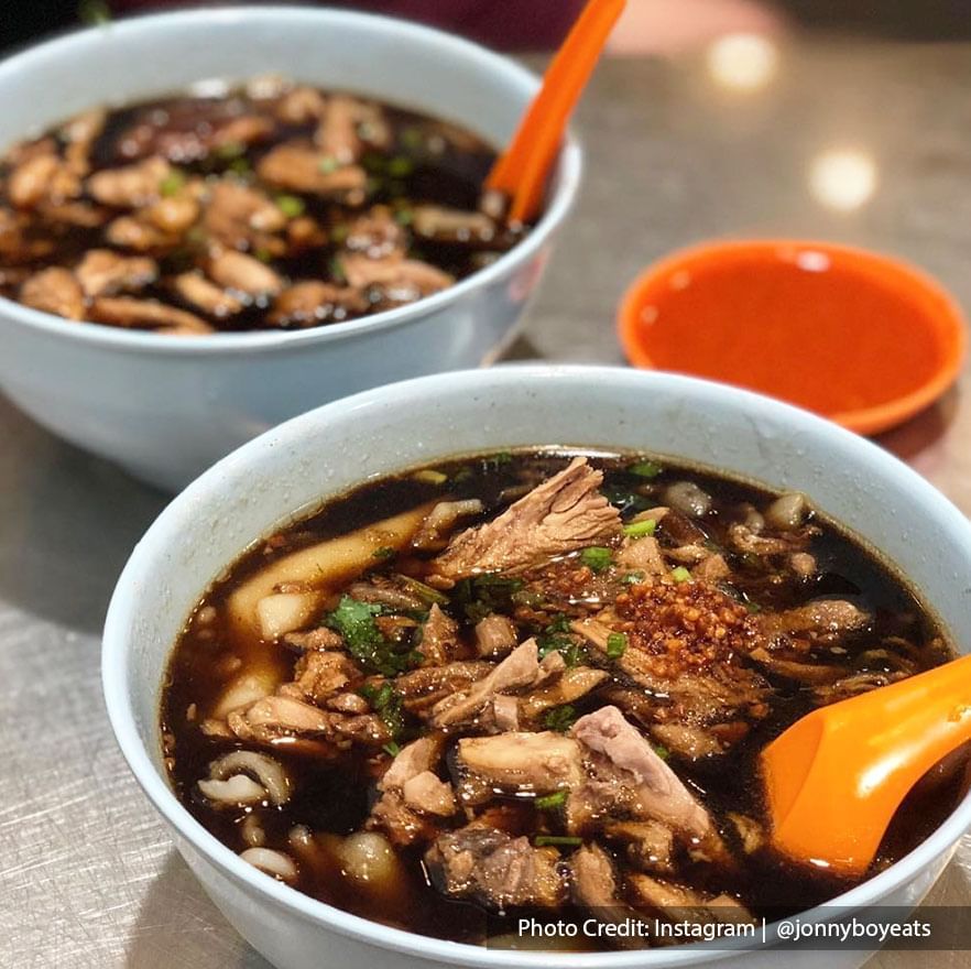 two bowls of duck kway chap on a table at hawker stall Penang