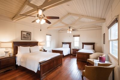 Beds and seating in One Queen and two Twins at Banning House Lodge, one of the places to stay in two harbors