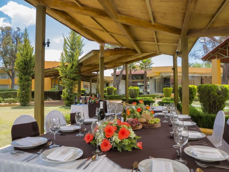 Table arranged with wine glasses & flowers in the Garden at Gamma Pachuca