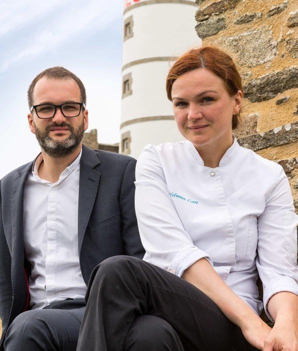 Chef & staff member by a brick wall at The Originals Hotels