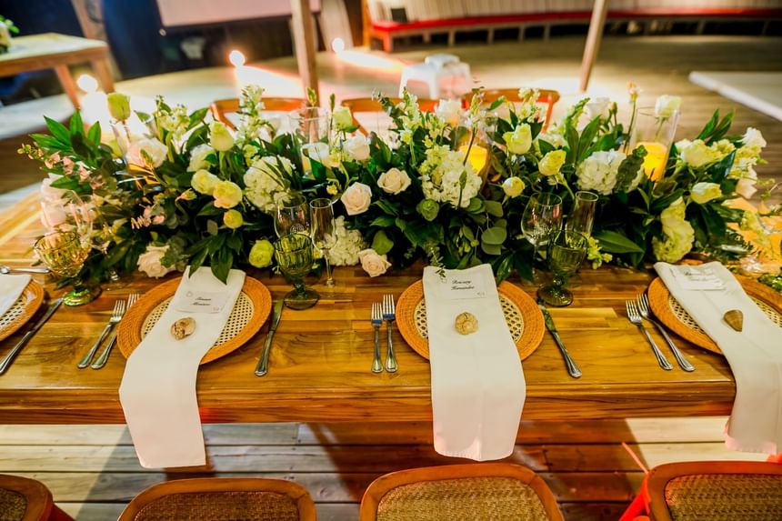 Dining table arranged with flowers and cutleries for wedding couple at Hotel Isla Del Encanto