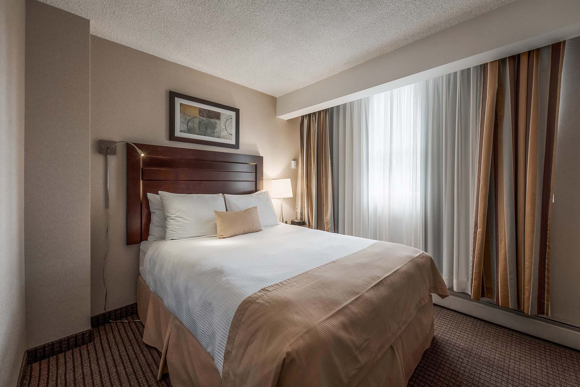 Queen bed in the second bedroom of our two bedroom suites