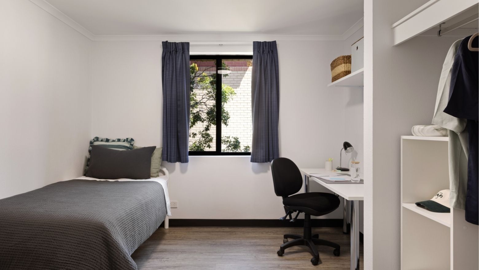 Clean and modern single bedroom with desk and window at UniLodge at Curtin University Erica Underwood House.