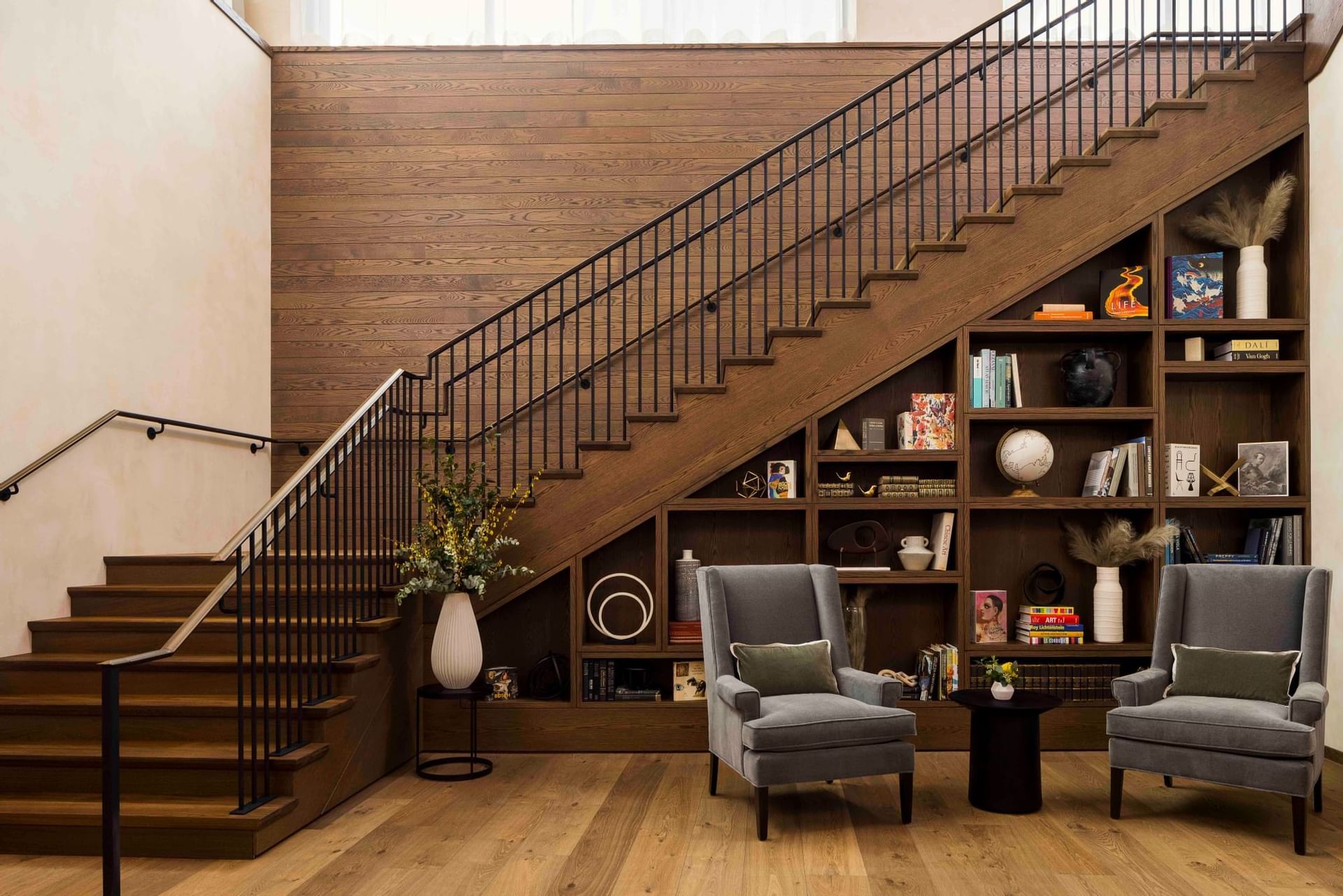 Lobby area with staircase and book shelf in The Study at University of Chicago