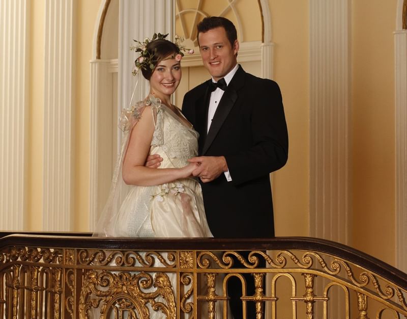 Wedding couple posing by the staircase at Peabody Memphis