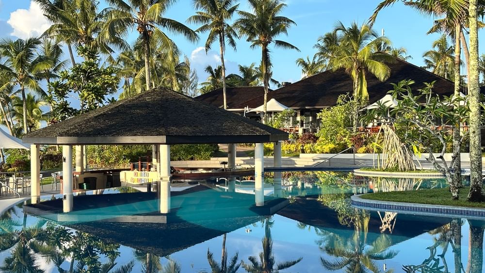 Clear pool and tropical surroundings with pavilion at Warwick Le Lagon Vanuatu in Efate.