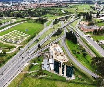 Aerial view of the contemporary multi-story hotel building near the highway cloverleaf junction at Unika Hotels countryside