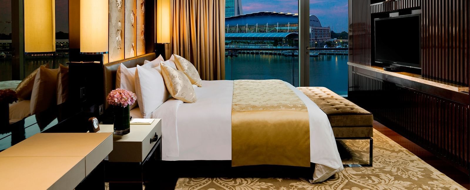Interior of a room with a king bed at Fullerton Bay Singapore