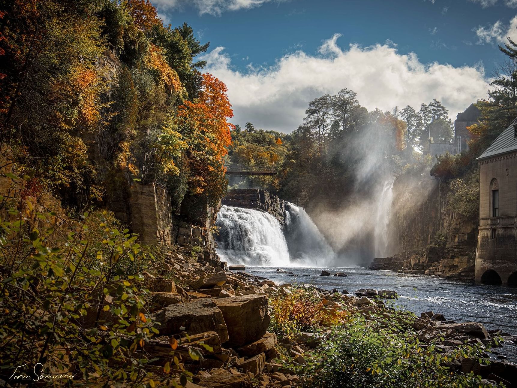 Waterfall surrounded by autumn-colored trees and a rocky gorge near High Peaks Resort