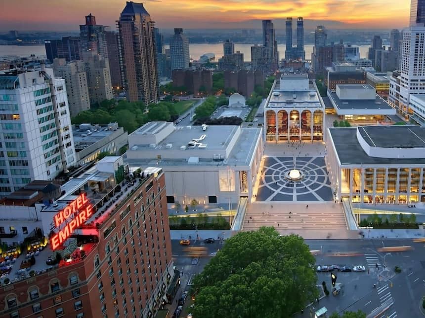 Aerial view of the Hotel Empire building in a city at sunset.