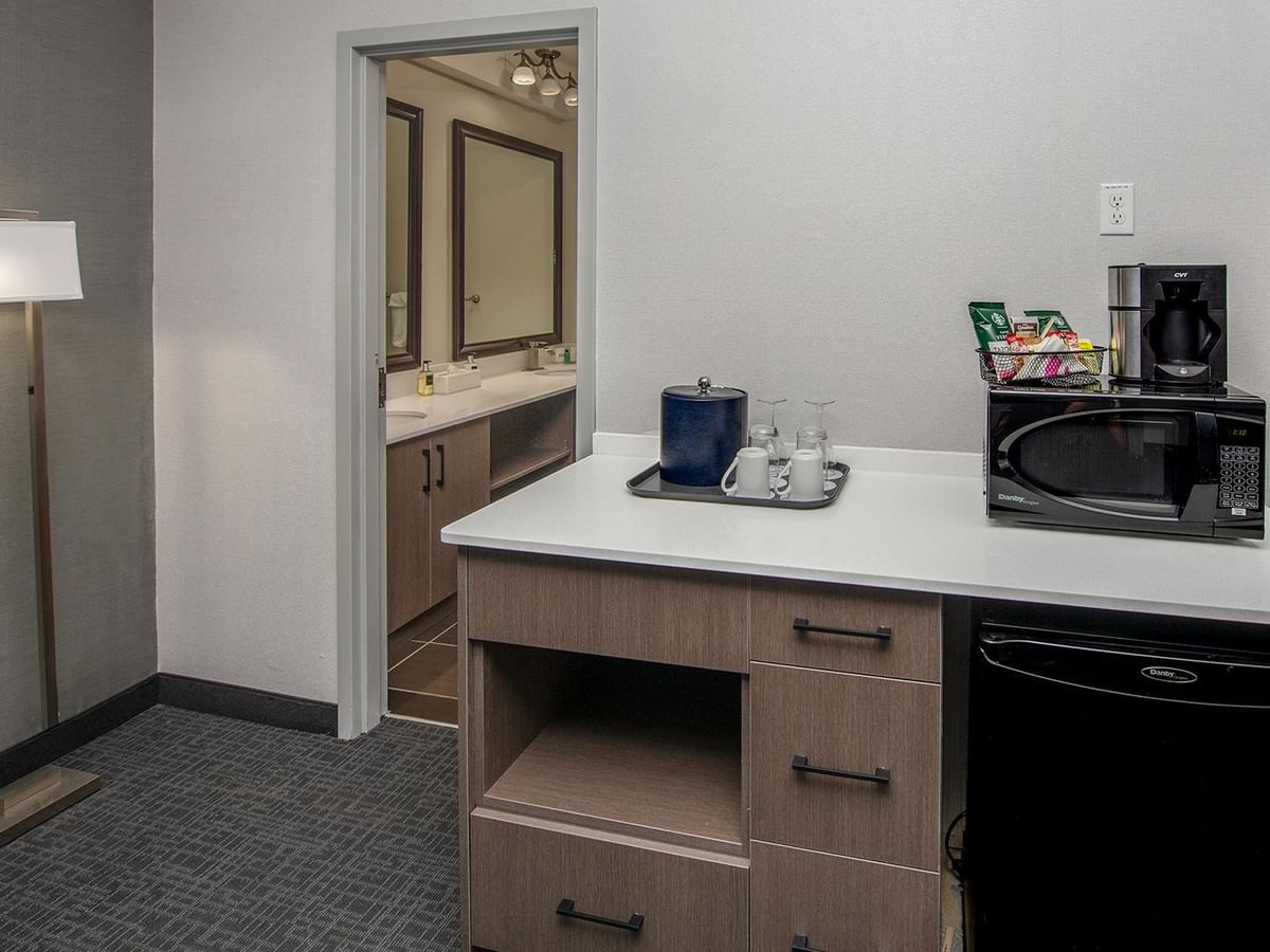 Microwave, coffee maker, and mini-fridge.