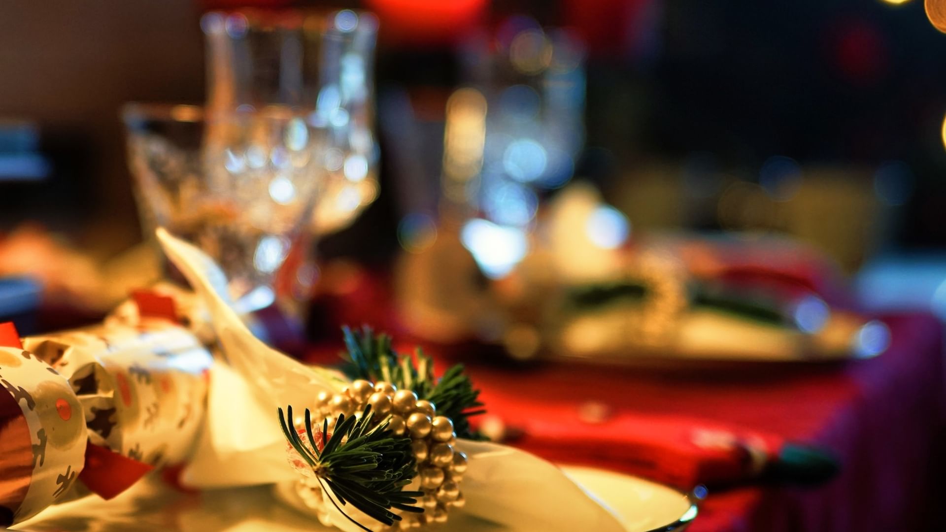 Festive table setting with wine glasses and a Christmas napkin ring for the Christmas Eve Buffet.
