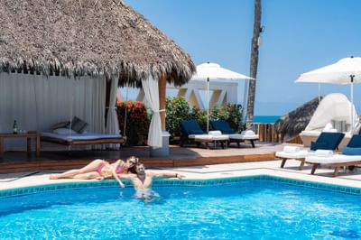 Couple enjoying outdoor pool area at Villa Premiere Boutique Hotel & Romantic Getaway