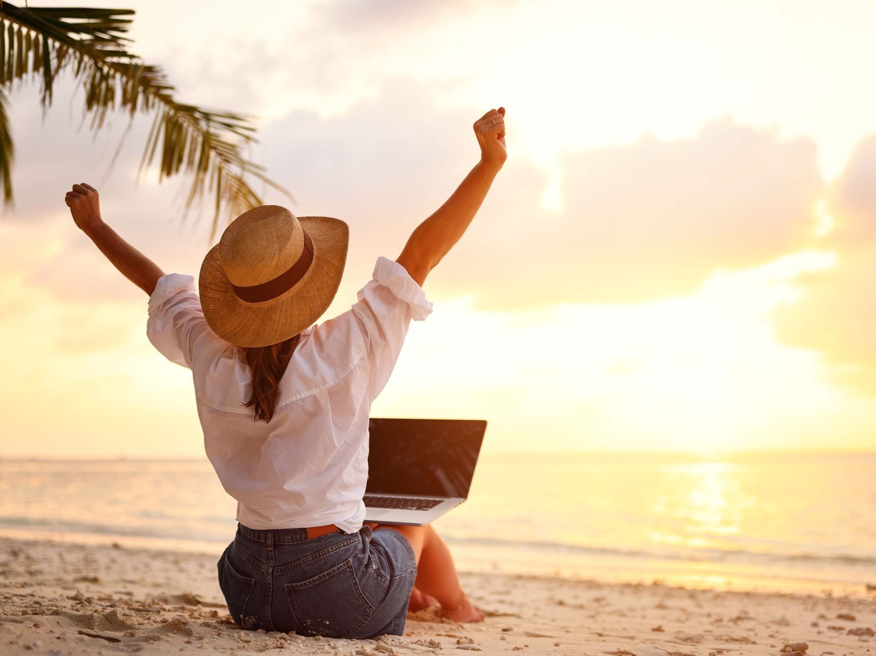 A girl on her laptop at the beach near Danna Langkawi Hotel