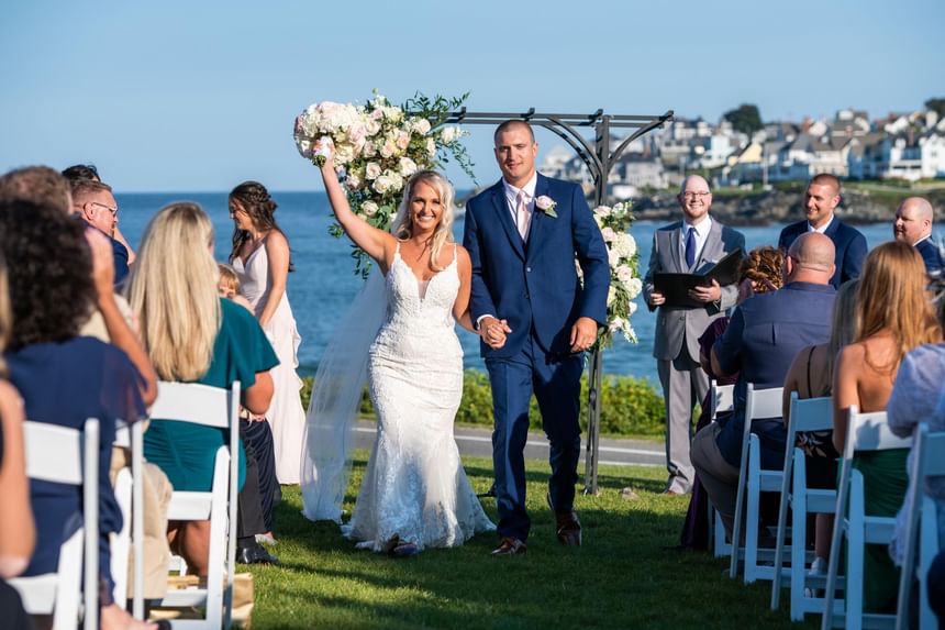 Bride & groom walking down the aisle with a Sea backdrop at Ogunquit Collection