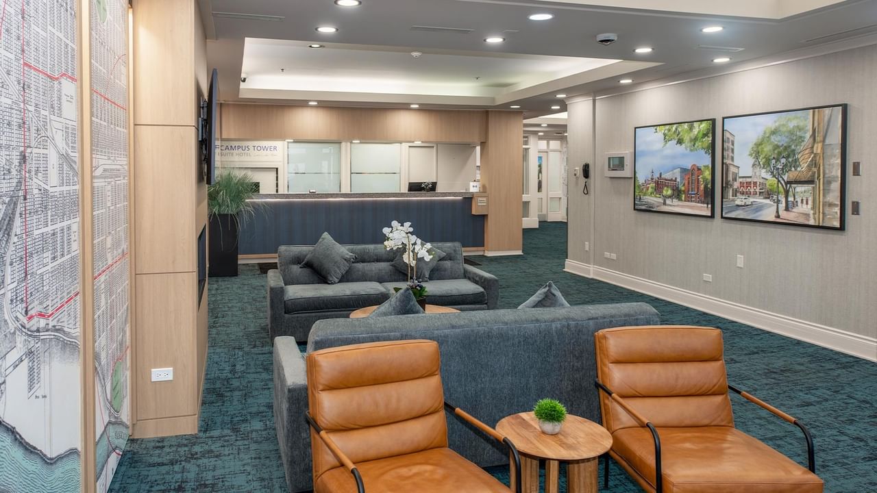 Hotel lobby with couches, chairs, and artwork in Campus Tower Suite Hotel.