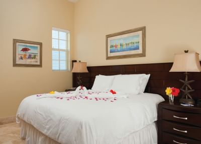 Comfy bed with rose petals in Standard Room at Windsong Resort On The Reef
