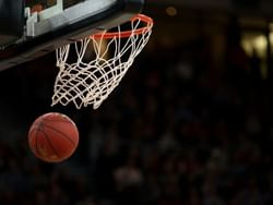 A basketball soaring through the hoop on a court at La Galerie Hotel