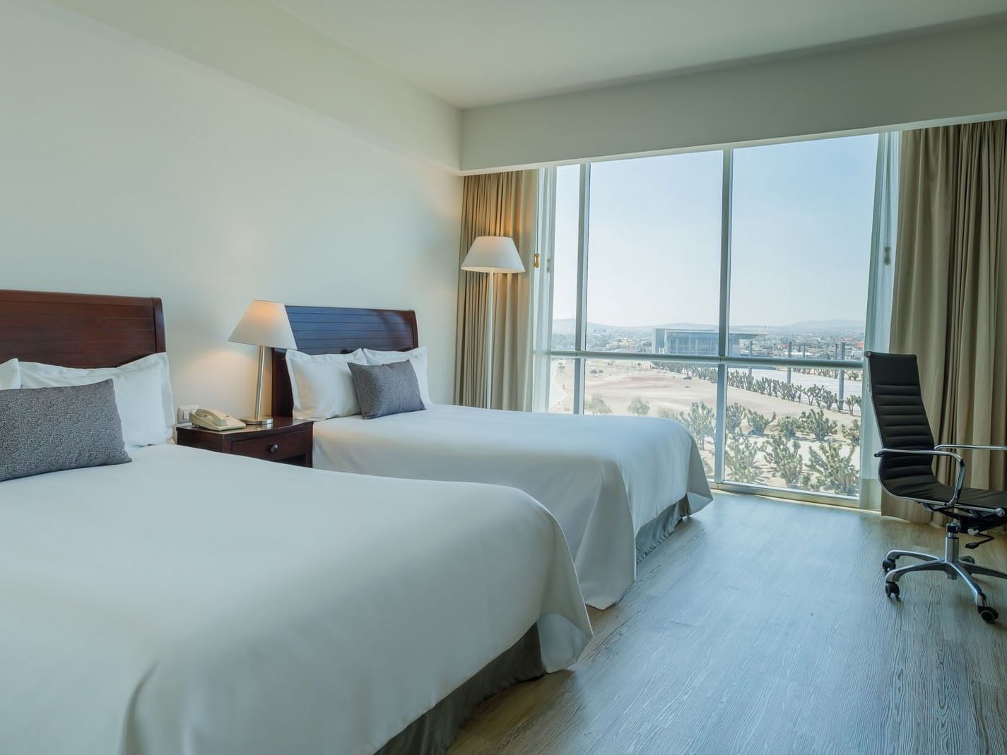 2 Double Camino Real Club offering large windows with a scenic view and a dedicated workspace at Camino Real Pachuca