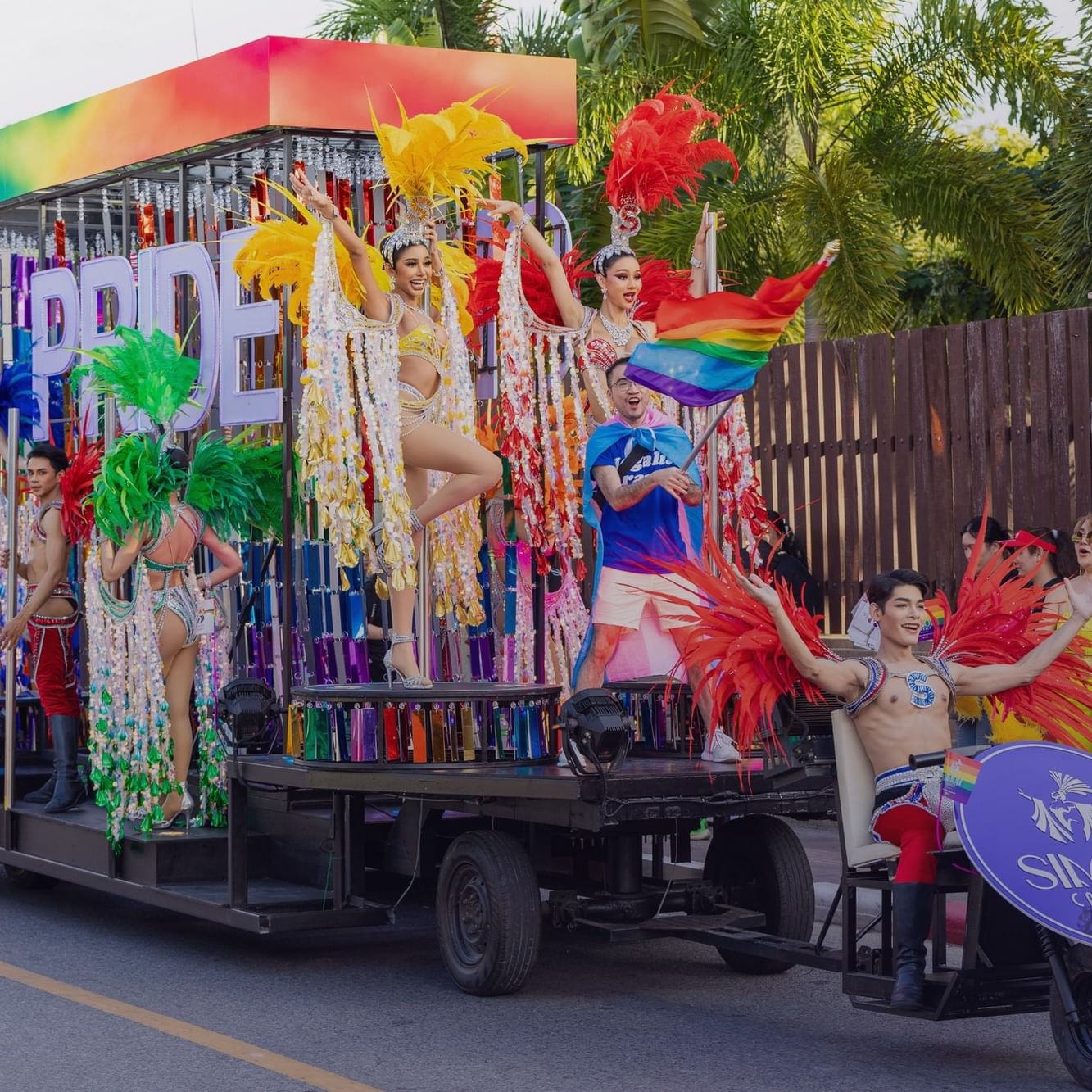Performers on a vibrant parade float at the Phuket Pride Parade.