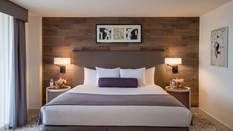 Comfy bed with side tables in Executive Suite at Warwick Denver