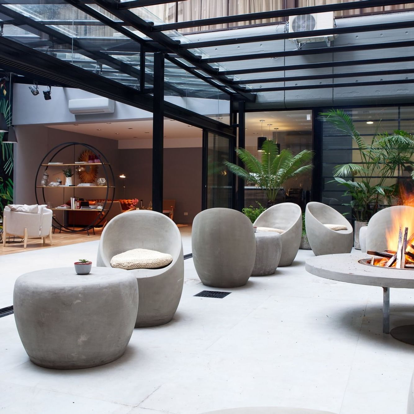 Lobby with a firepit & lounge area at DecO Recoleta Hotel