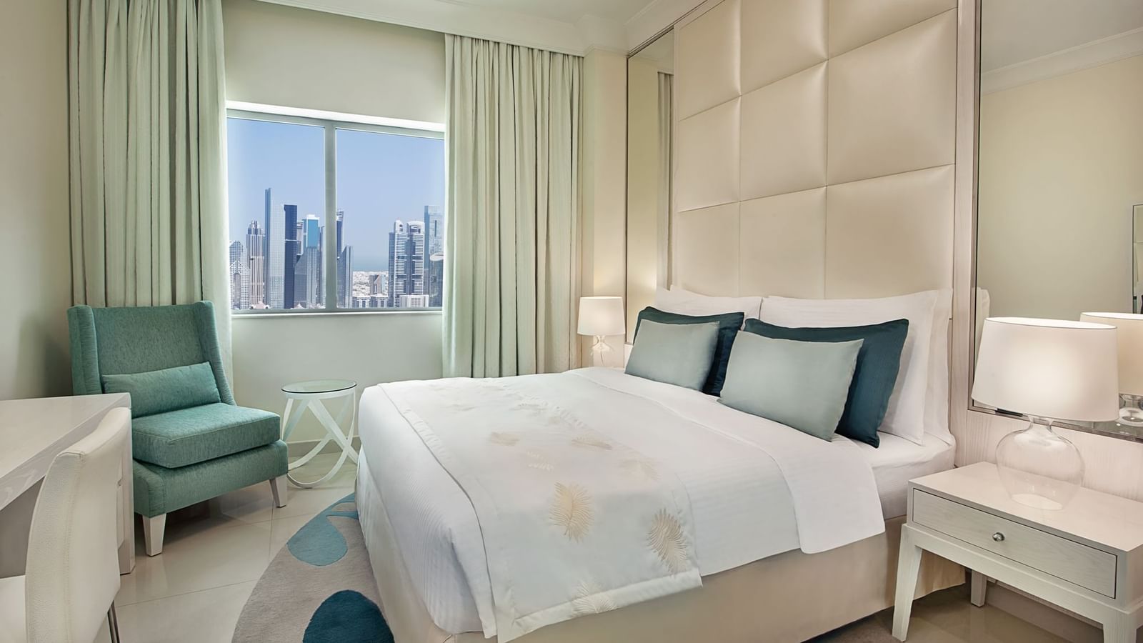 Bed with nightstands and city view in One Bedroom Suite at DAMAC Maison Mall Street