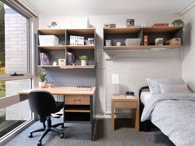 Comfortable single room with desk and bed at La Trobe University – Menzies College.