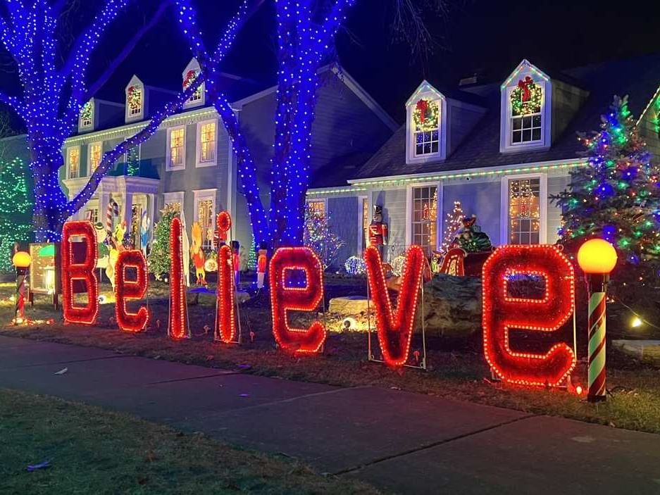 house with lights that says believe