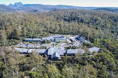 Aerial view of cradle mountain hotel sorrounded by trees