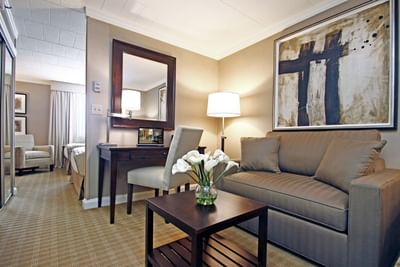 Sitting area with a work desk in suite at Ethan Allen Hotel