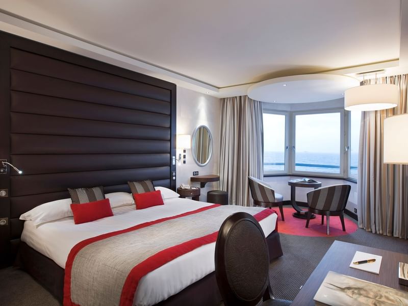 Double bed with seating area in Croisiere Grand Large Room at Le Grand Hôtel des Thermes