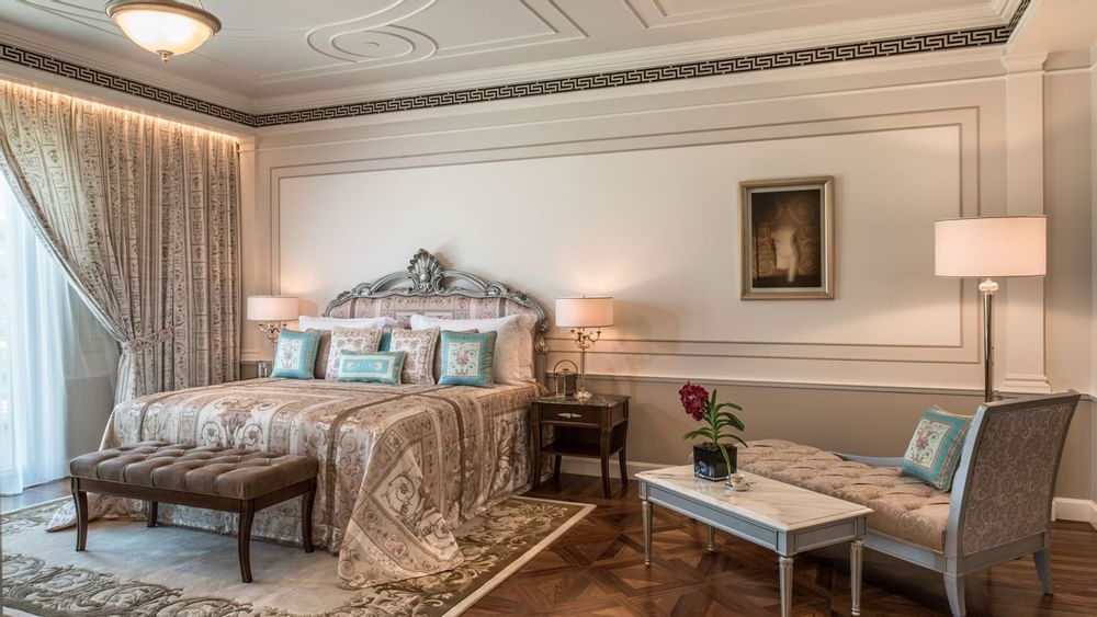 Bedroom with king bed, lamps & sofa at Palazzo Versace Dubai