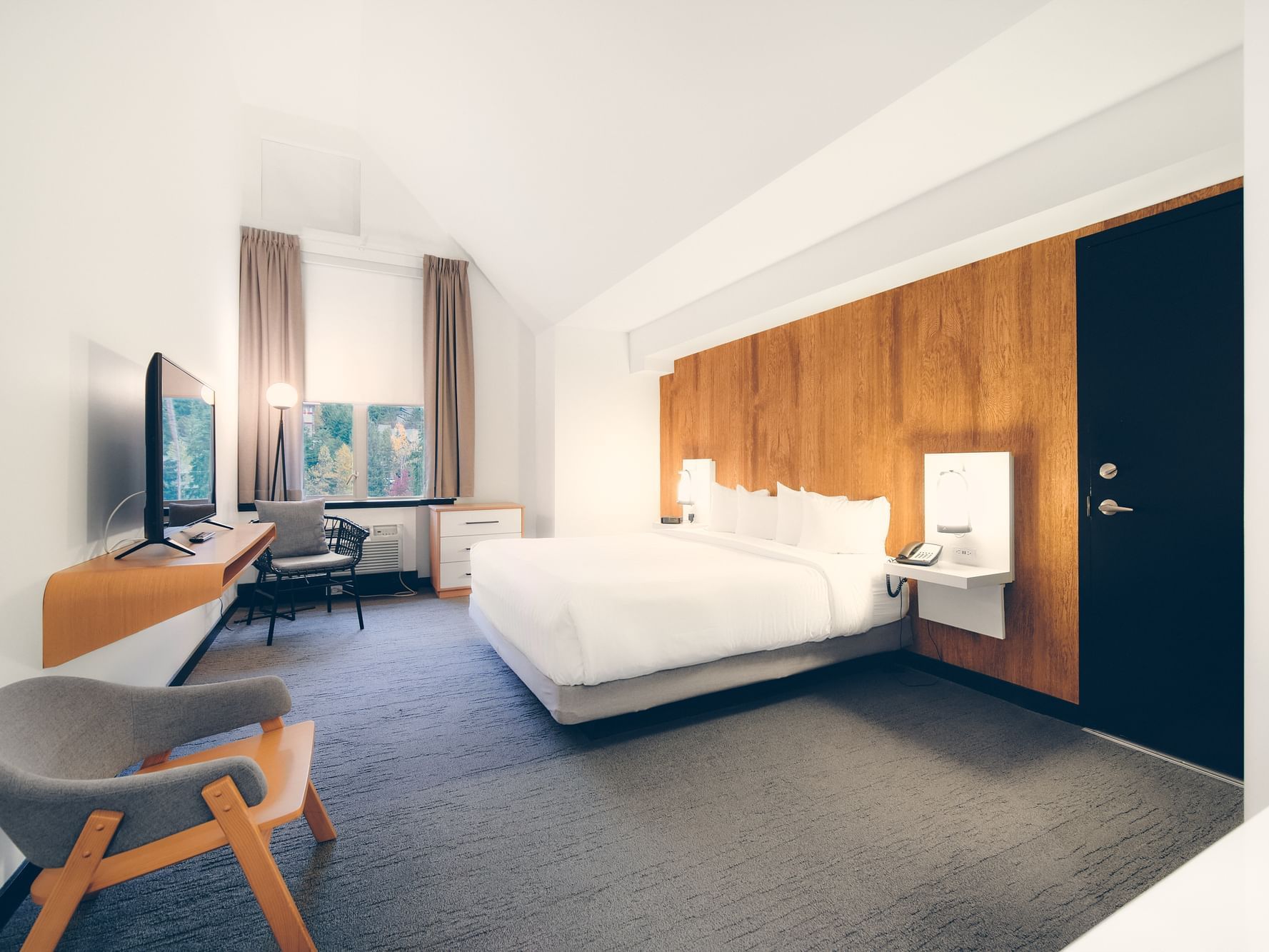 Bed in hotel room with window