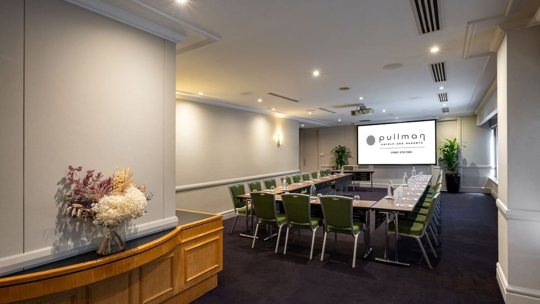 U-shape table set-up with projector screen in Parkview Room at Pullman Sydney Hyde Park