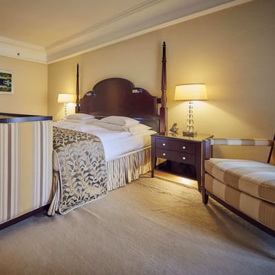 Bed & lounge in Superior Room King at Falkensteiner Hotels