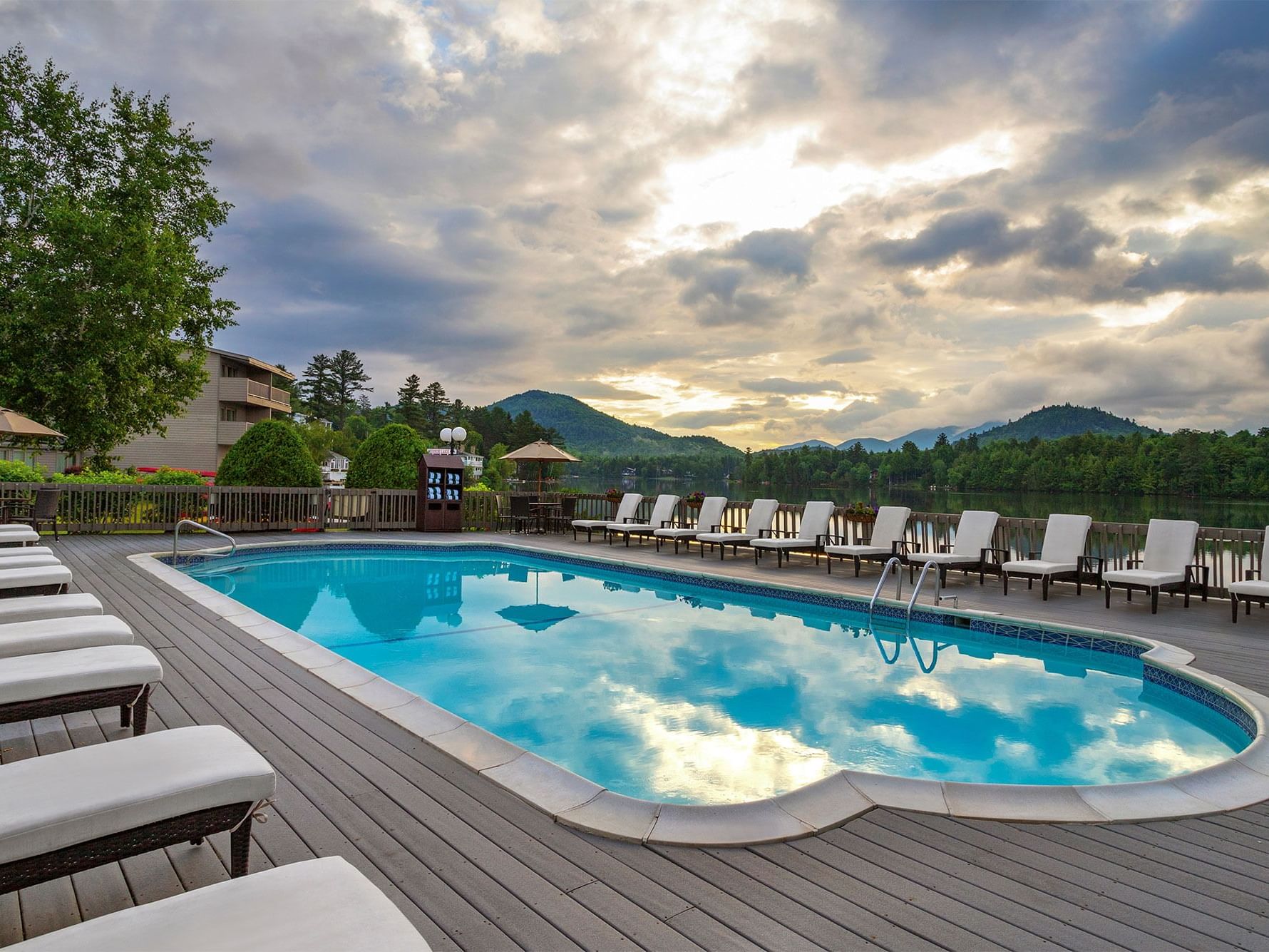 Outdoor pool with lounge chairs at High Peaks Resort in Lake Placid.