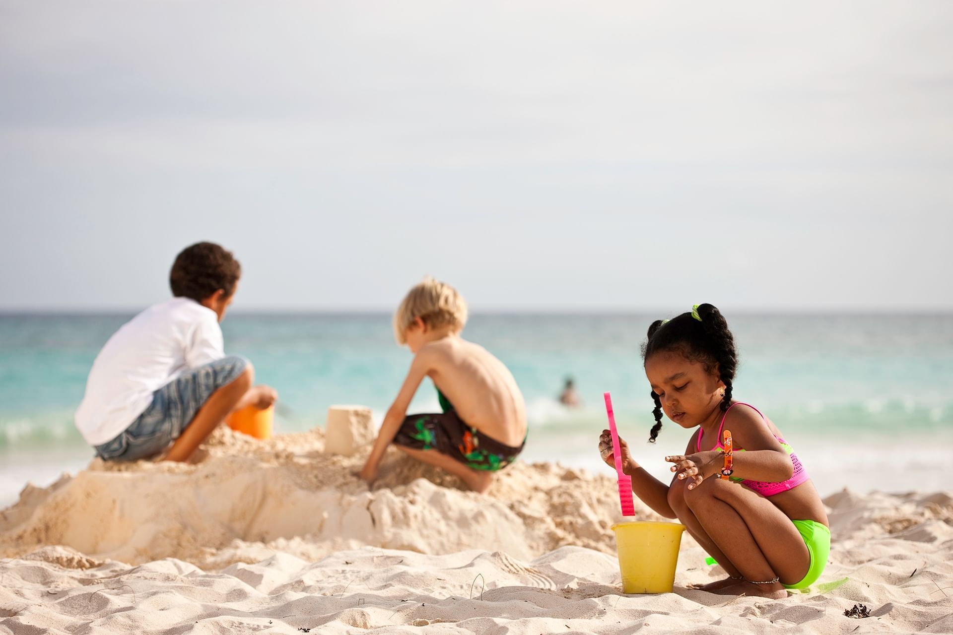 The children on the sand. Playing on the Beach. Holiday at the Beach.