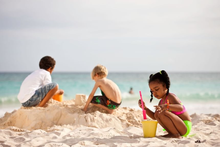 Kids playing with sand on the beach at Sugar Bay Barbados