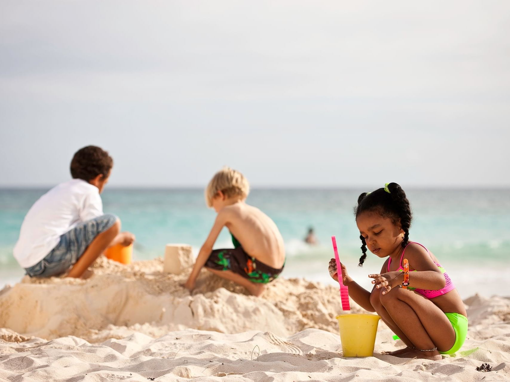 Kids playing with sand on the beach near Sugar Bay Barbados