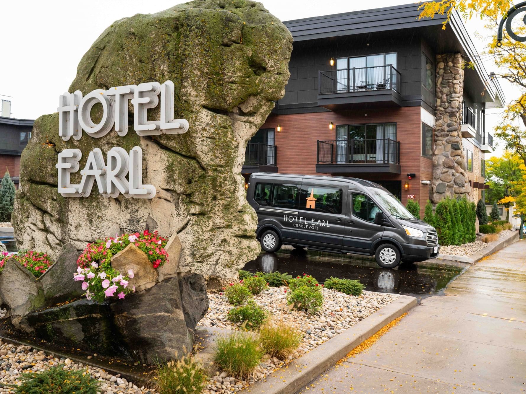 Hotel shuttle van parked by the front entrance at The Earl