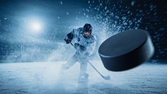 Hockey puck by a player in motion under arena lights near Paramount Hotel Seattle